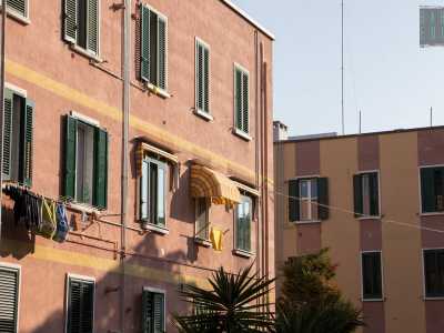 ...composto da basse e colorate case popolari senza balconi disposte su stradine che di colpo si fanno parallele e perpendicolari